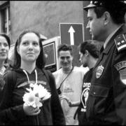 Activist holding flowers in front of police