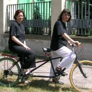 Two women on a bicycle for two
