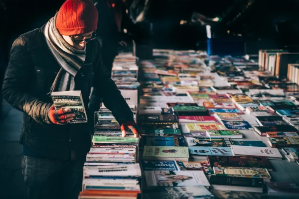 A man browses a table full of books