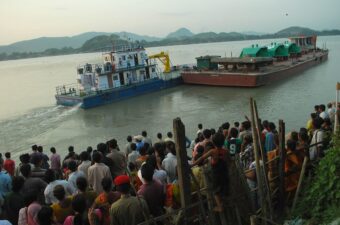 Activists of the KMSS farmers' rights movement block turbines for the Lower Subansiri Dam from being unloaded