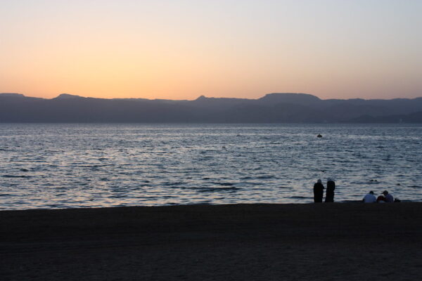 People in the distance at Aqaba, the Red Sea at sunset.