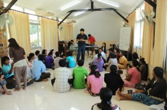 A group of Burmese migrants attend a talk on human rights in Thailand