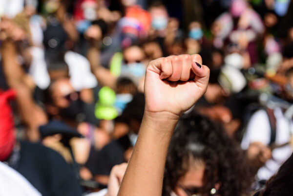 A raised fist amongst a blurred sea of protestors