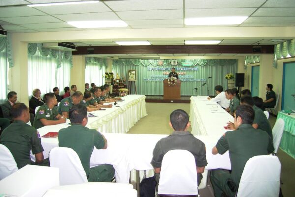 Men sit around a table at a police training in Thailand