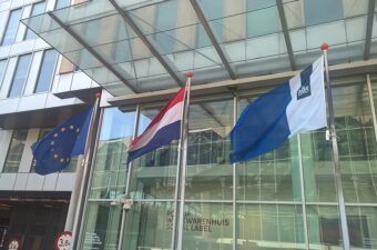 Photo of the Dutch and EU flags at the Hague