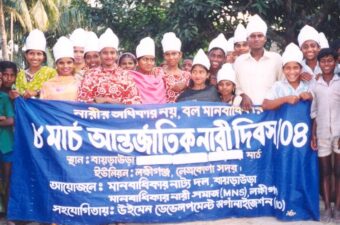 Motahar community action group holding a blue sign with white lettering