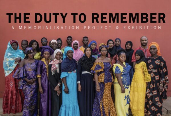 A group of women in Gambia stand together. The words "The Duty to Remember" are at the top.