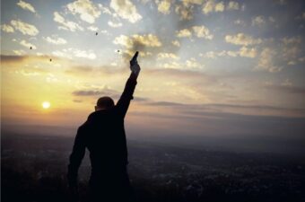 A man fires a gun into the air.