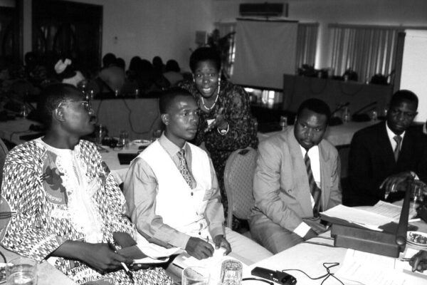 Community leaders in Liberia sit at a table