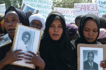 Families of the disappeared holding their photos