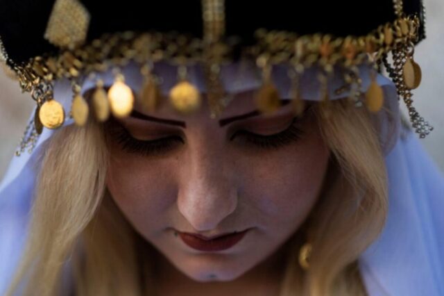 Close-up of a Yazidi woman in traditional clothing.