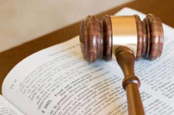 A judge's gavel laying on the pages of legislation