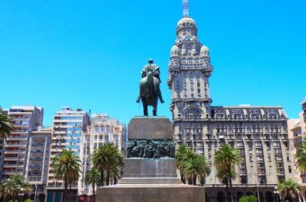 A statue and buildings in the background in Independence Square, Montevideo Uruguay