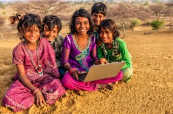 happy children using laptop in India