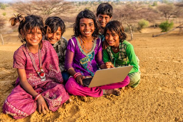 happy children using laptop in India