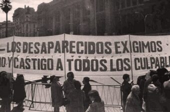 Protestors holding a sign demanding accountability for the disappeared in Argentina