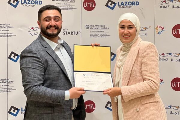 Basil Ibrahim accepting a certificate from global program manager, Noor Zada