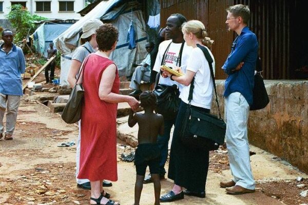 Minnesota Advocates team conducting on-site investigation of conditions at an amputee camp in Sierra Leone.