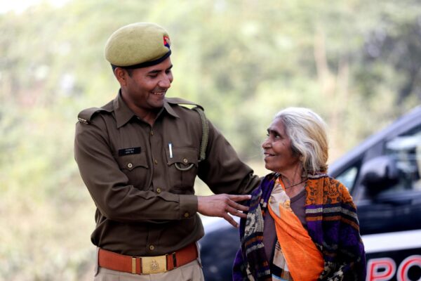 police officer helping a woman in India