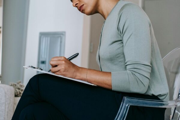 Cropped image of a therapist making notes