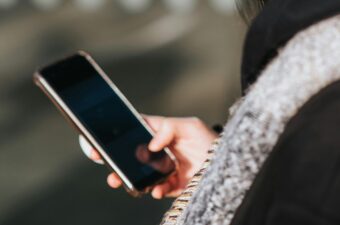 Cropped image of a woman looking at her phone