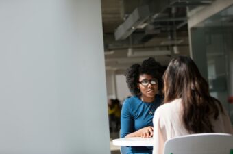 A black woman appears to be completing a job interview.