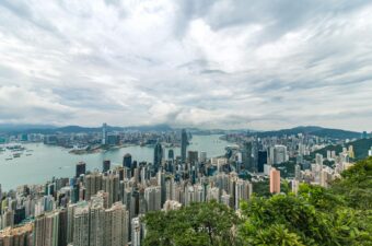 City Buildings and Green Trees Near Ocean in Hong Kong