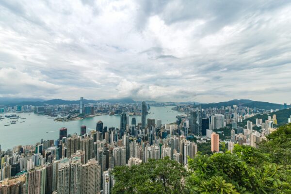 City Buildings and Green Trees Near Ocean in Hong Kong