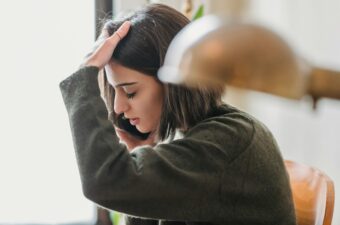 A woman appears distressed while talking on the phone.