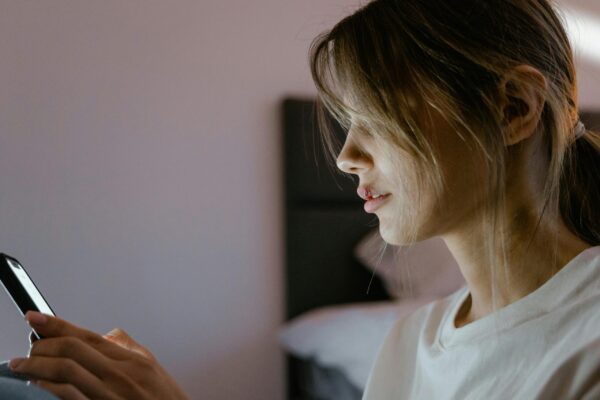 Close-Up Shot of a Woman Using a Mobile Phone, appearing to have a busted lip.