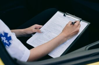 A paramedic sitting and making a report