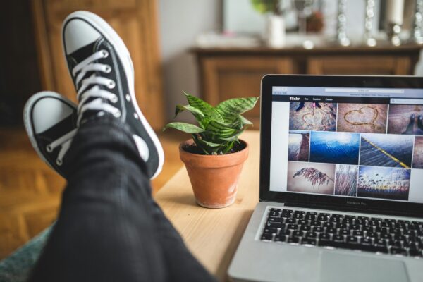 Feet up on a desk, with the flickr website open on the computer