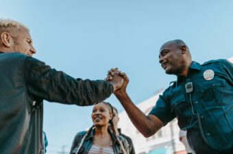 A police officer greets community members