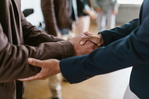 Cropped image of two people shaking hands.