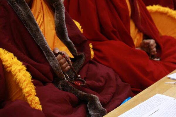 Cropped image of Buddhist monks sitting