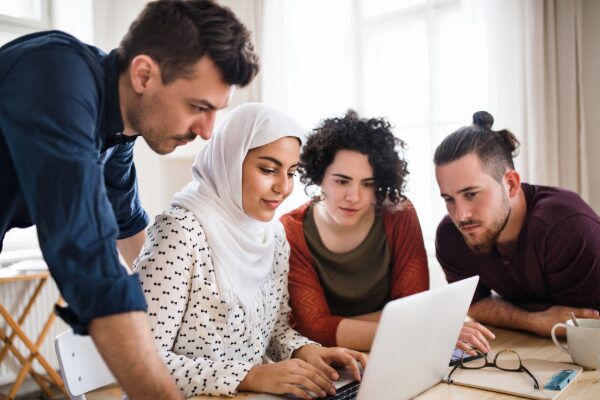 People gathered around a computer